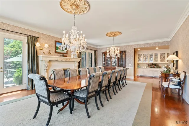 a dining room with furniture a chandelier and wooden floor