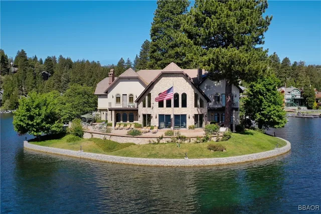 a view of a house with pool and sitting area