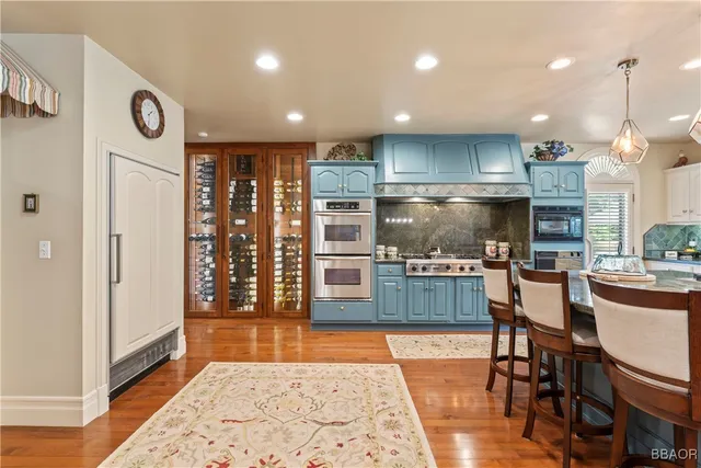 a kitchen with stainless steel appliances granite countertop a refrigerator and a stove top oven