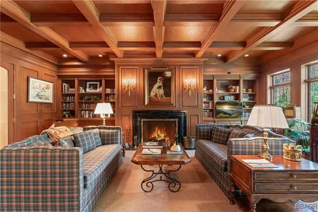 a living room with furniture a fireplace and next to a window