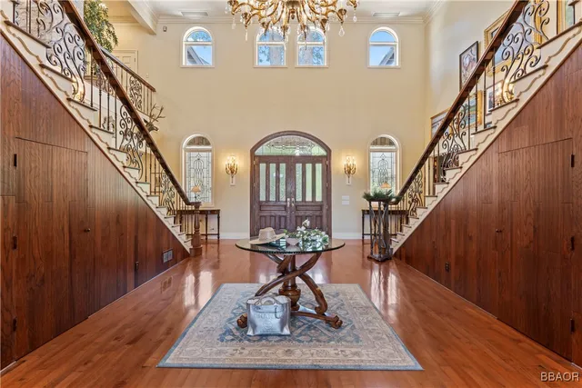 a view of entryway and hall with wooden floor