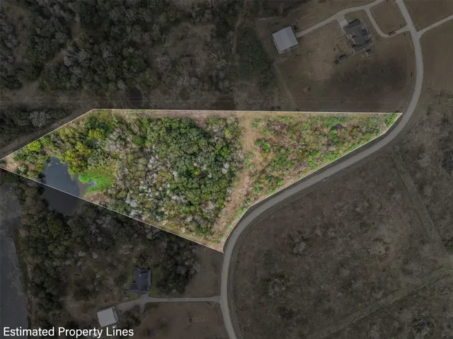 a view of a yard with wooden fence