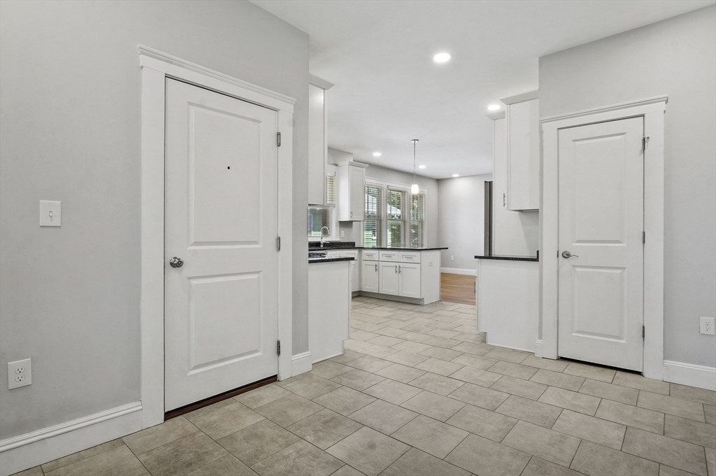 91 Verndale Street, Unit 1 Brookline, MA 02446 - Photo 3 of 16 a view of a kitchen with white cabinets
