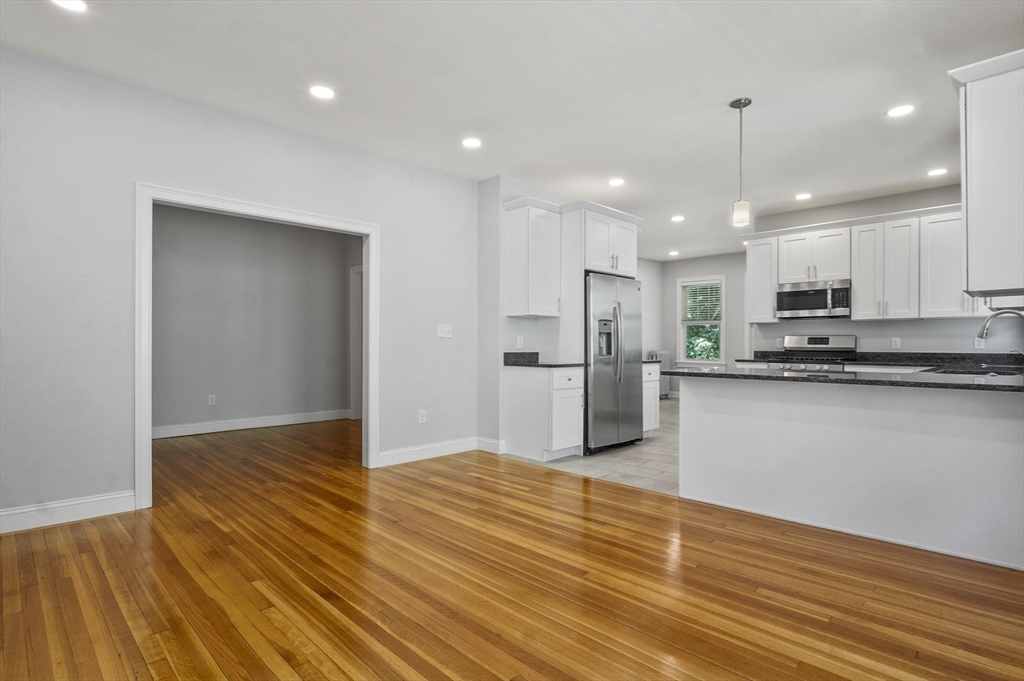 91 Verndale Street, Unit 1 Brookline, MA 02446 - Photo 8 of 16 a view of kitchen view wooden floor stainless steel appliances and cabinets