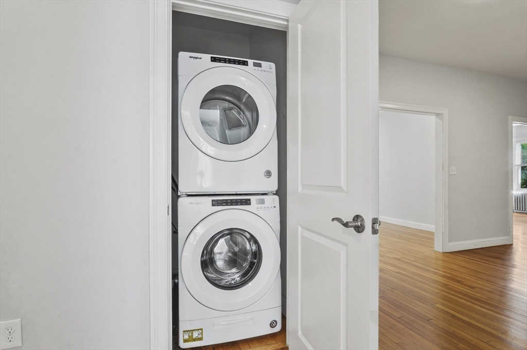 91 Verndale Street, Unit 1 Brookline, MA 02446 - Photo 9 of 16 a view of a hallway with washer and dryer