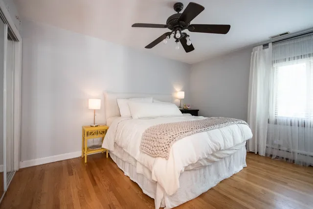 a bedroom with a bed and wooden floor