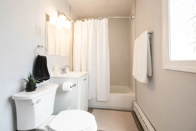 a bathroom with a sink a toilet and tub