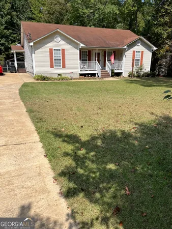 a front view of a house with a garden