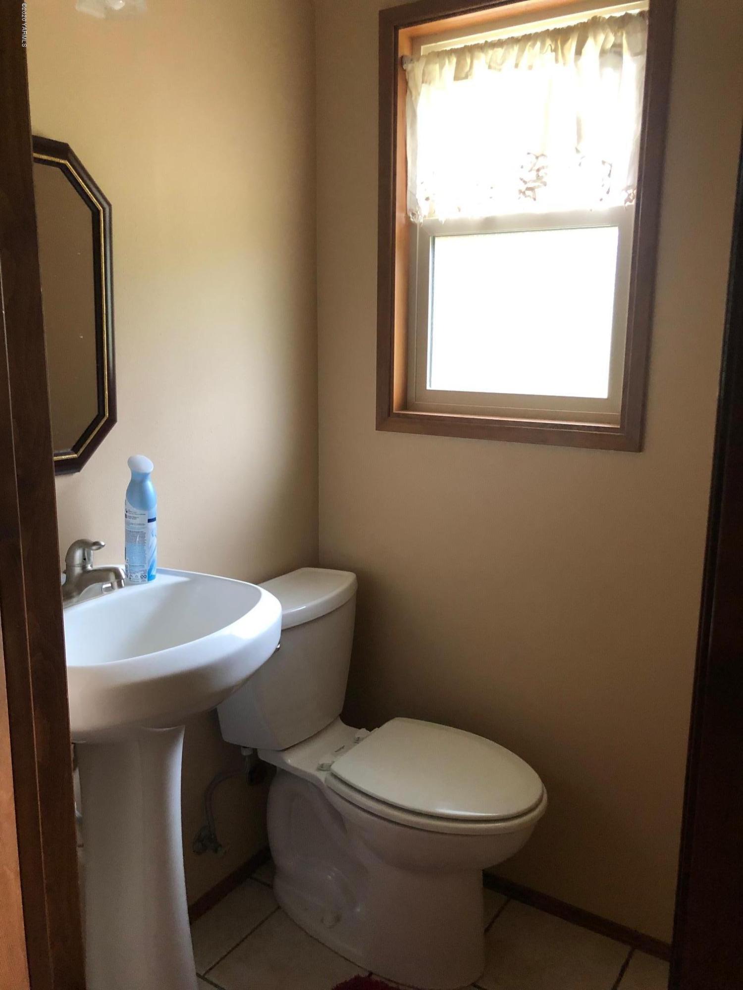 170 St Mary Road Harrah, WA 98933 - Photo 21 of 26 a bathroom with a sink a toilet and a mirror
