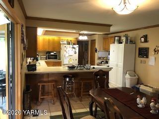 170 St Mary Road Harrah, WA 98933 - Photo 24 of 26 a kitchen with stainless steel appliances granite countertop table chairs and a refrigerator