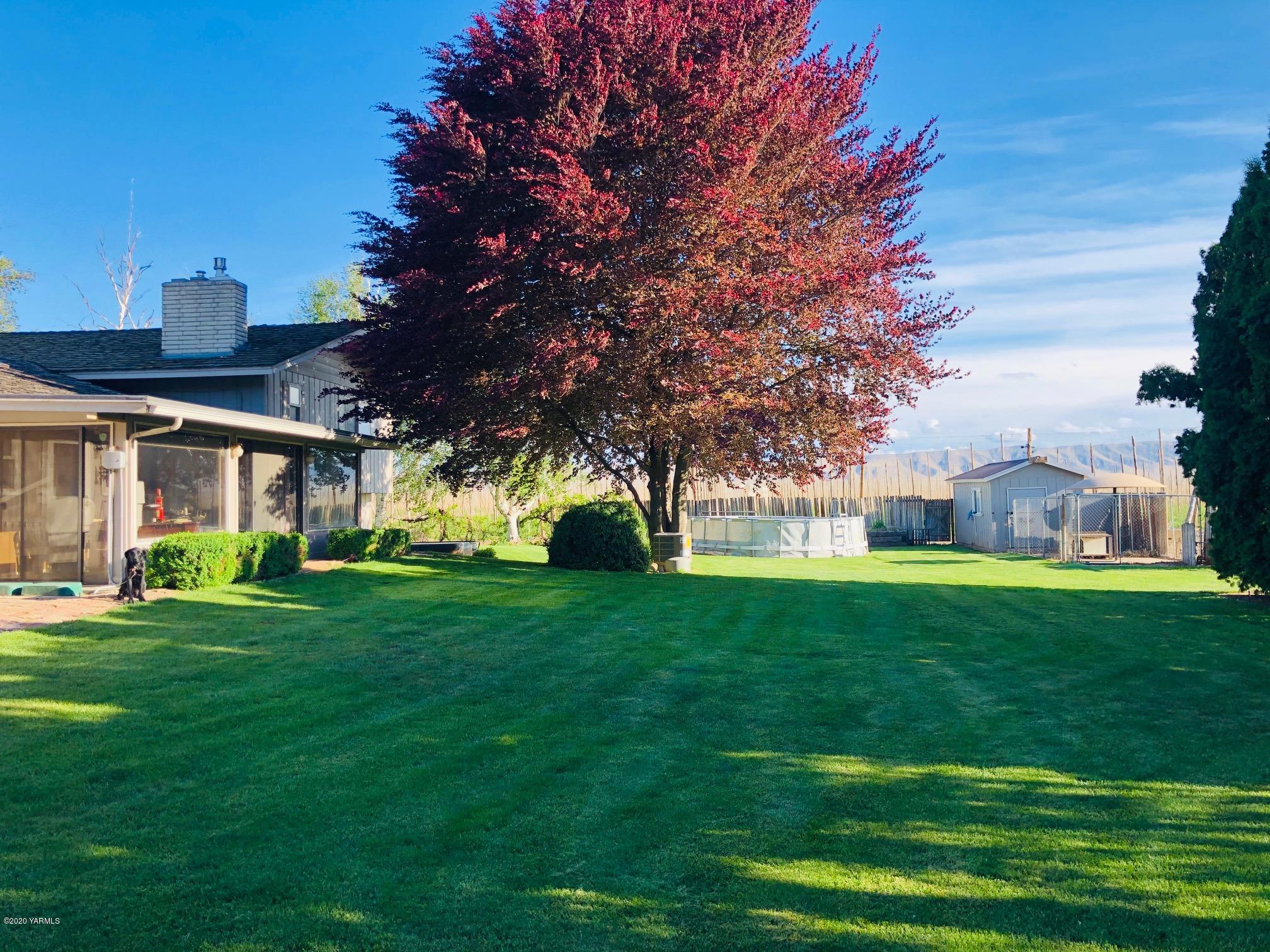 170 St Mary Road Harrah, WA 98933 - Photo 7 of 26 a view of a big building with big yard and large trees