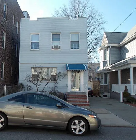 a view of a car parked in front of a house