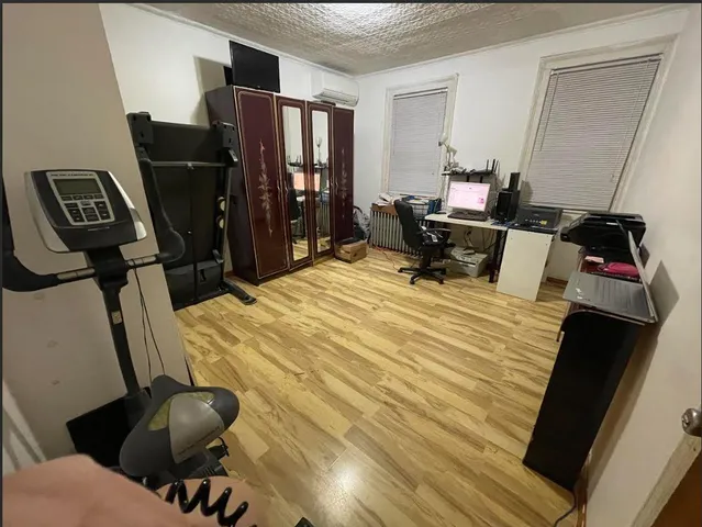 a bedroom with bed and mirror