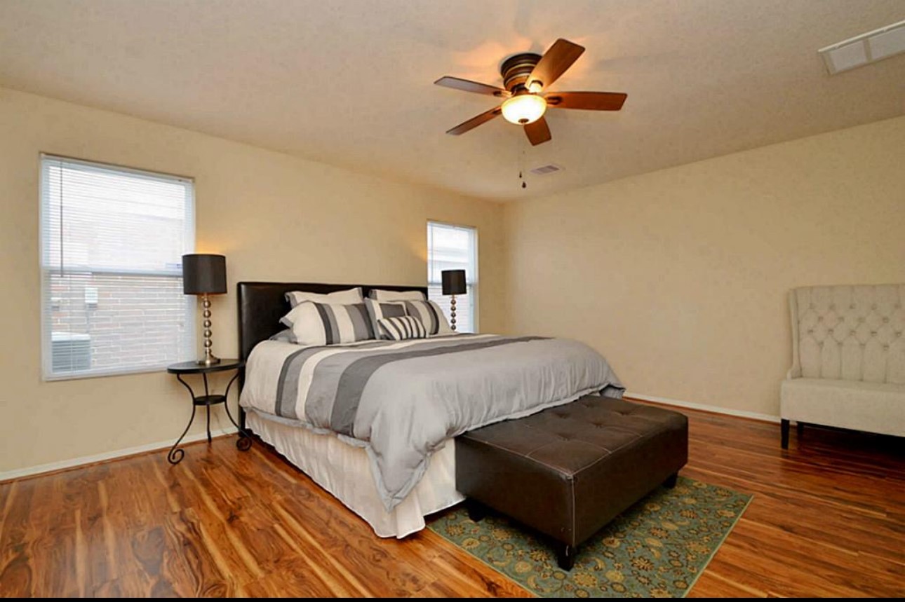 20606 Ricewood Village Trail Katy, TX 77449 - Photo 14 of 17 a bedroom with a bed couch and window