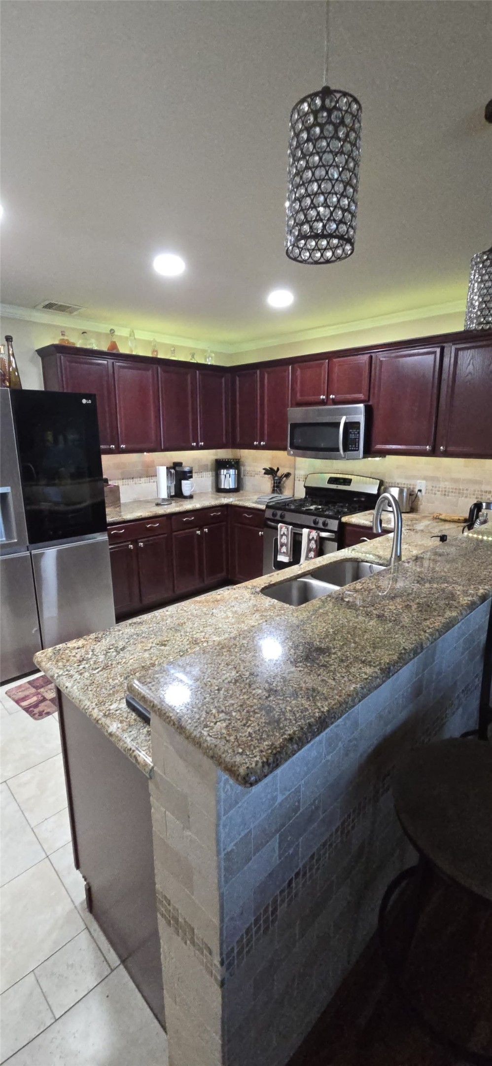 20606 Ricewood Village Trail Katy, TX 77449 - Photo 6 of 17 a kitchen with stainless steel appliances granite countertop a sink a stove and a microwave