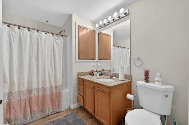 a bathroom with a toilet a sink and a mirror