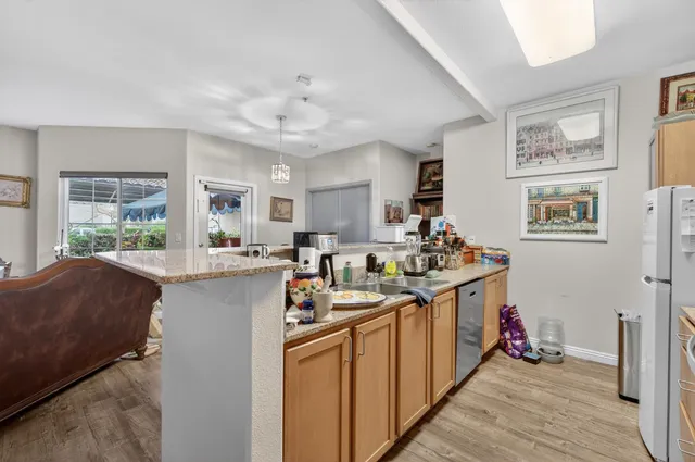 a kitchen with stainless steel appliances granite countertop a sink stove and wooden cabinets