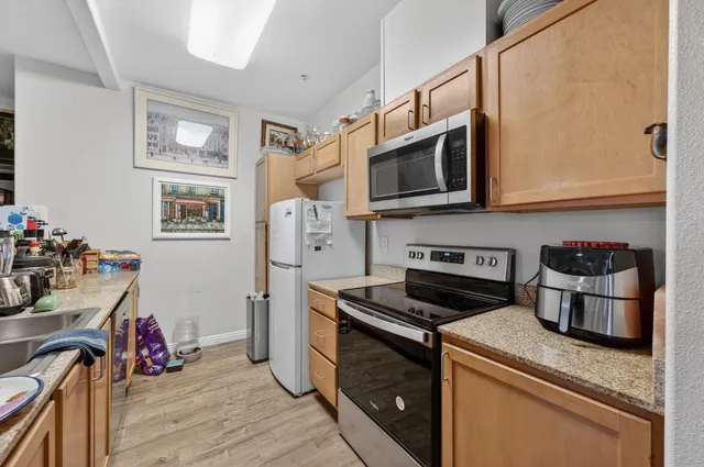 a kitchen with stainless steel appliances granite countertop a stove and a microwave