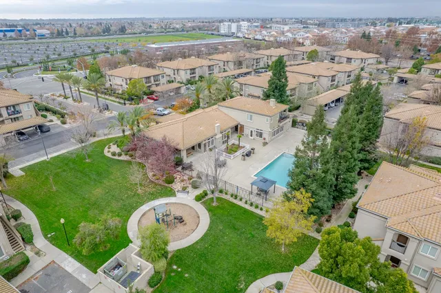 an aerial view of a house with garden space and street view