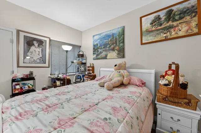 a bedroom with bed and cupboard