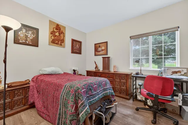 a bedroom with a bed and a desk