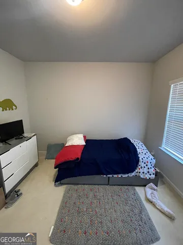 a room with a dresser and a window