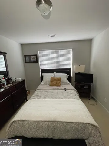 a bedroom with a bed and cabinets