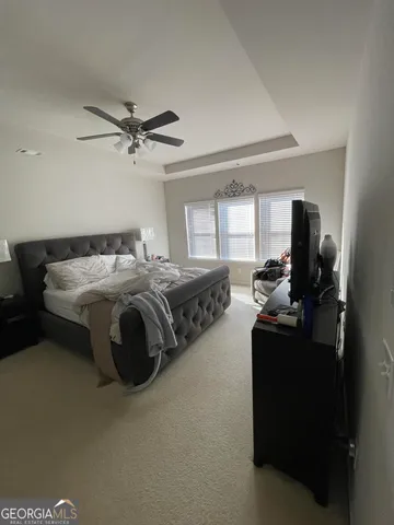 a bedroom with bed and a chandelier