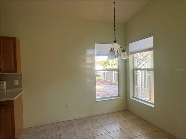 a room with window and chandelier