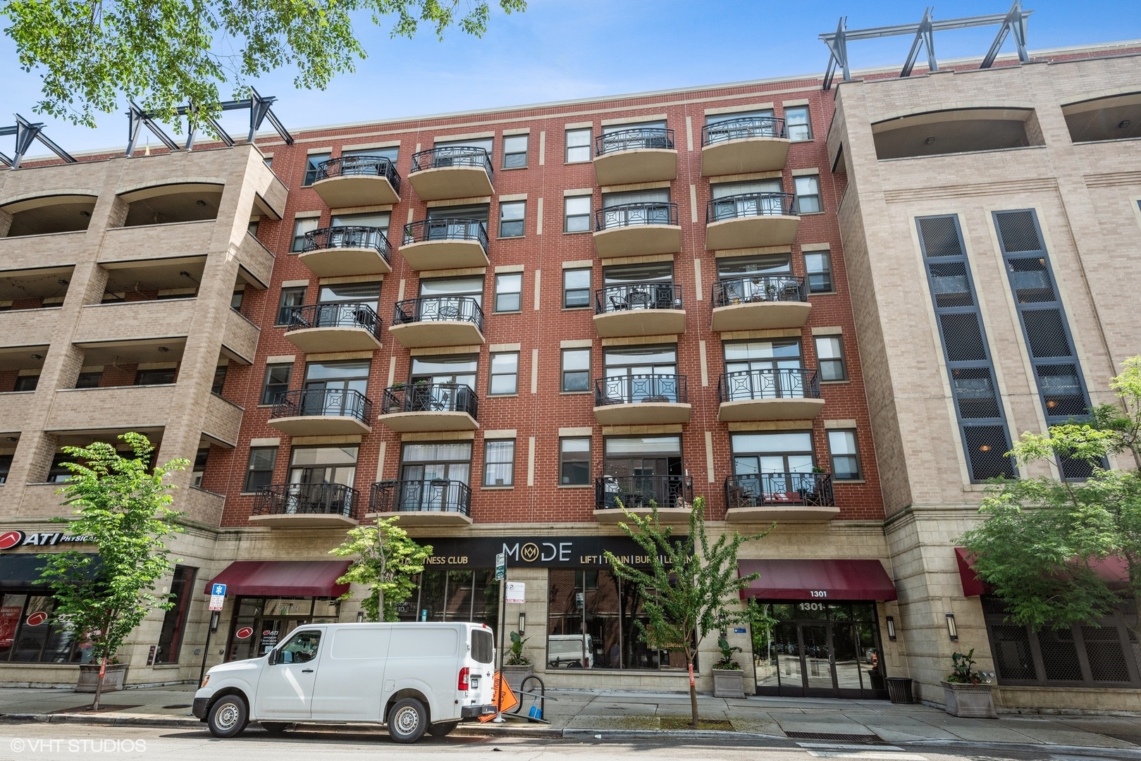 1301 West Madison Street, Unit 603 Chicago, IL 60607 - Photo 1 of 24 a front view of a building with lot of windows