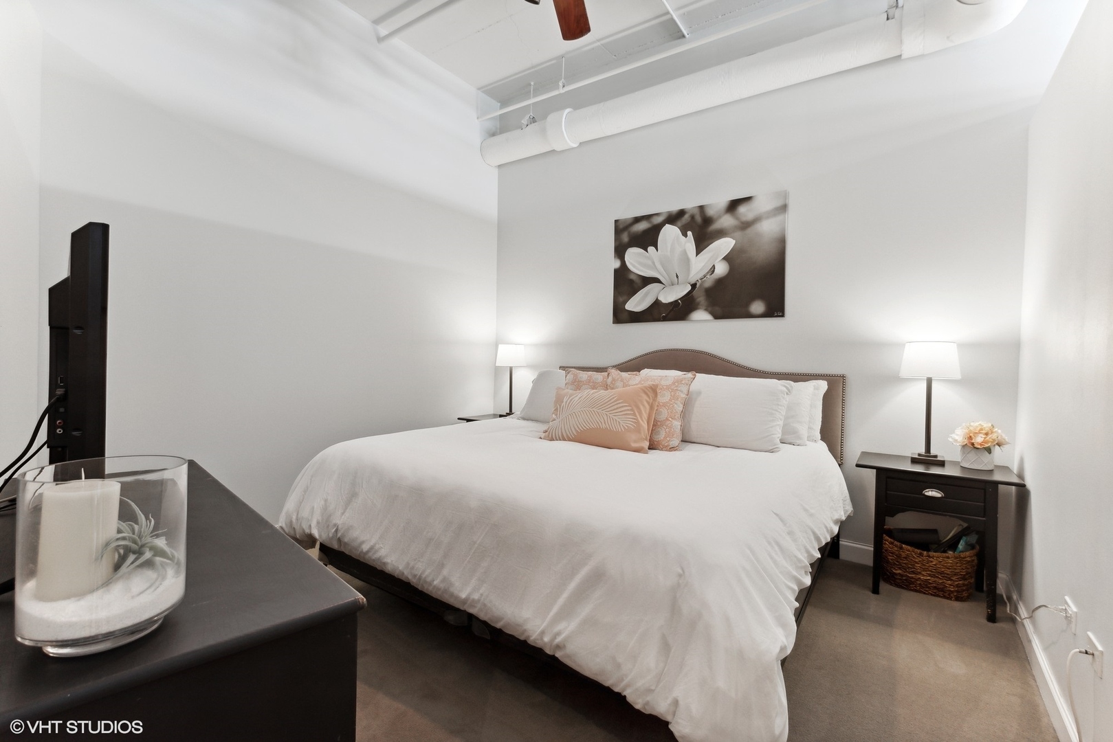 1301 West Madison Street, Unit 603 Chicago, IL 60607 - Photo 13 of 24 a bedroom with a bed and a lamp on the dresser