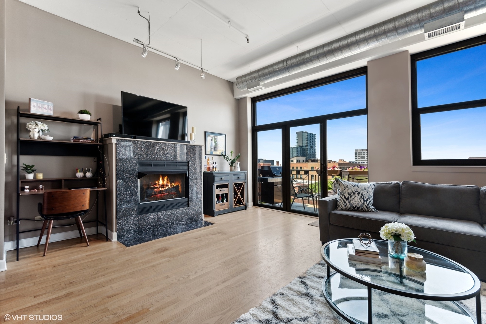1301 West Madison Street, Unit 603 Chicago, IL 60607 - Photo 2 of 24 a living room with furniture fireplace and flat screen tv