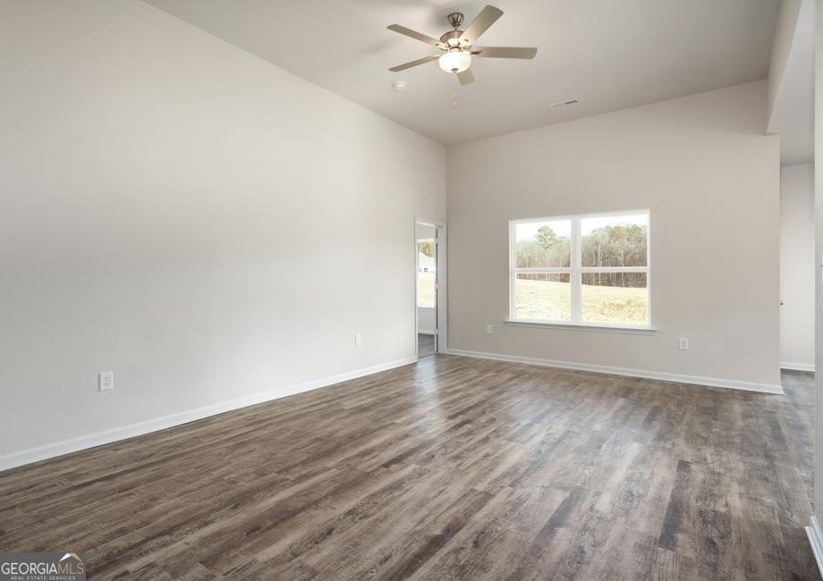 115 Darter Court Hoschton, GA 30548 - Photo 2 of 8 a view of an empty room with wooden floor and a window