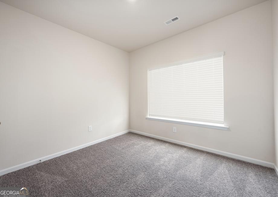 115 Darter Court Hoschton, GA 30548 - Photo 7 of 8 an empty room with a window