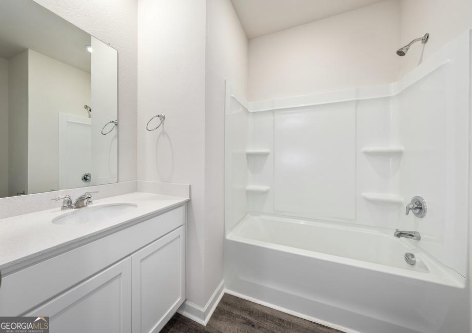115 Darter Court Hoschton, GA 30548 - Photo 8 of 8 a bathroom with a bathtub and a sink
