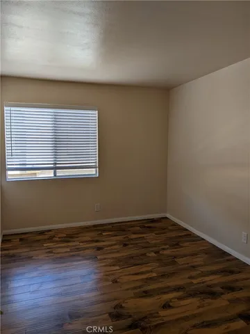 a view of a room with wooden floor and window