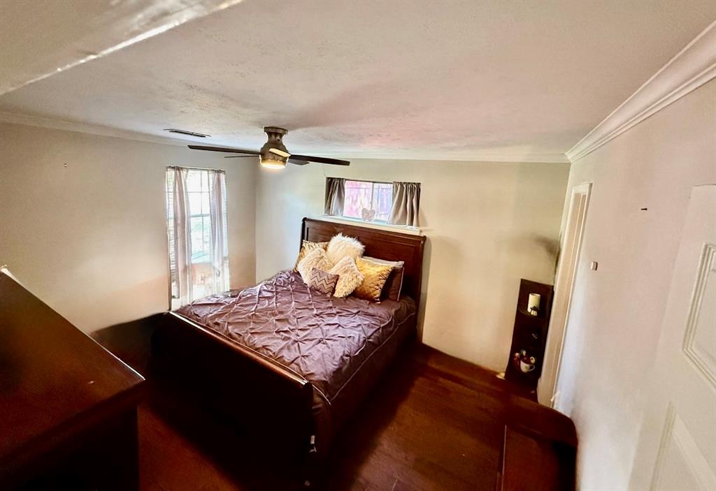 2888 Reedcroft Drive Farmers Branch, TX 75234 - Photo 10 of 32 a bedroom with a bed and wooden floor