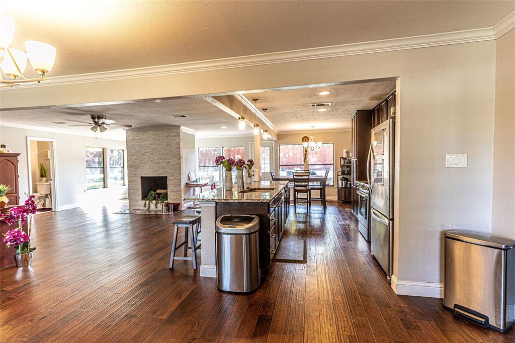 2888 Reedcroft Drive Farmers Branch, TX 75234 - Photo 3 of 32 a view of a living room and kitchen with a wooden floor