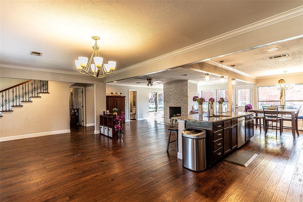2888 Reedcroft Drive Farmers Branch, TX 75234 - Photo 32 of 32 Kitchen with a chandelier, hanging light fixtures, open floor plan, a breakfast bar area, and ornamental molding