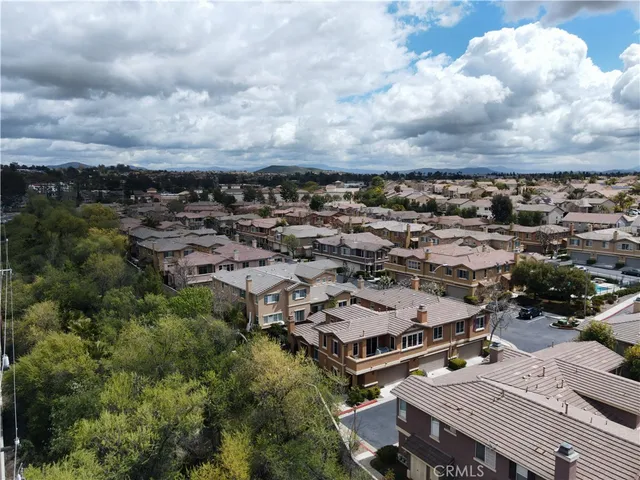 an aerial view of a houses with a city view