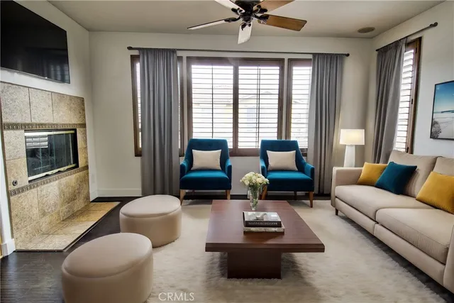 a living room with furniture a flat screen tv and a large window