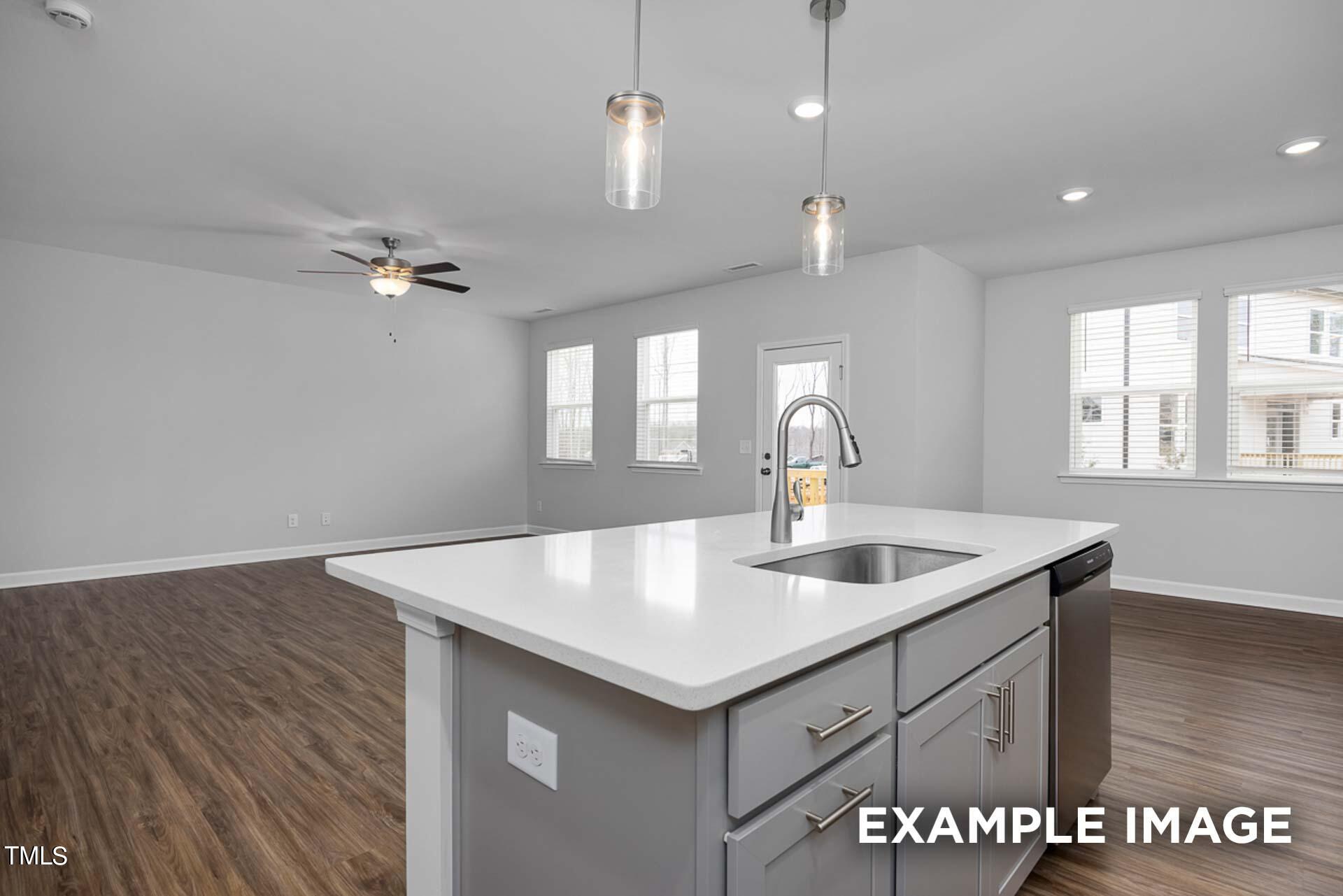 802 Rollingwheel Road Mebane, NC 27302 - Photo 11 of 40 a kitchen with a sink a counter space and wooden floor