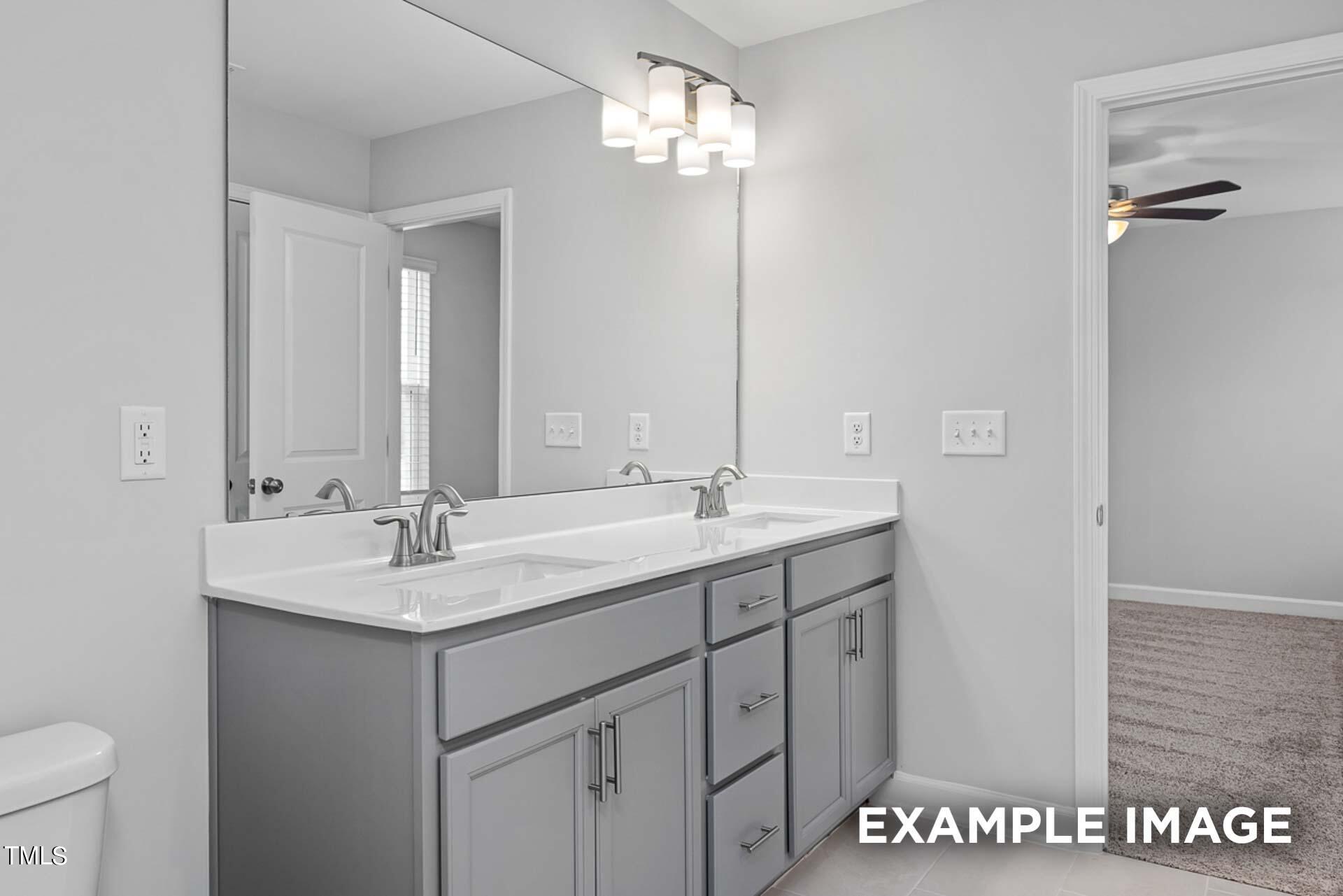 802 Rollingwheel Road Mebane, NC 27302 - Photo 16 of 40 a bathroom with a sink double vanity and a mirror