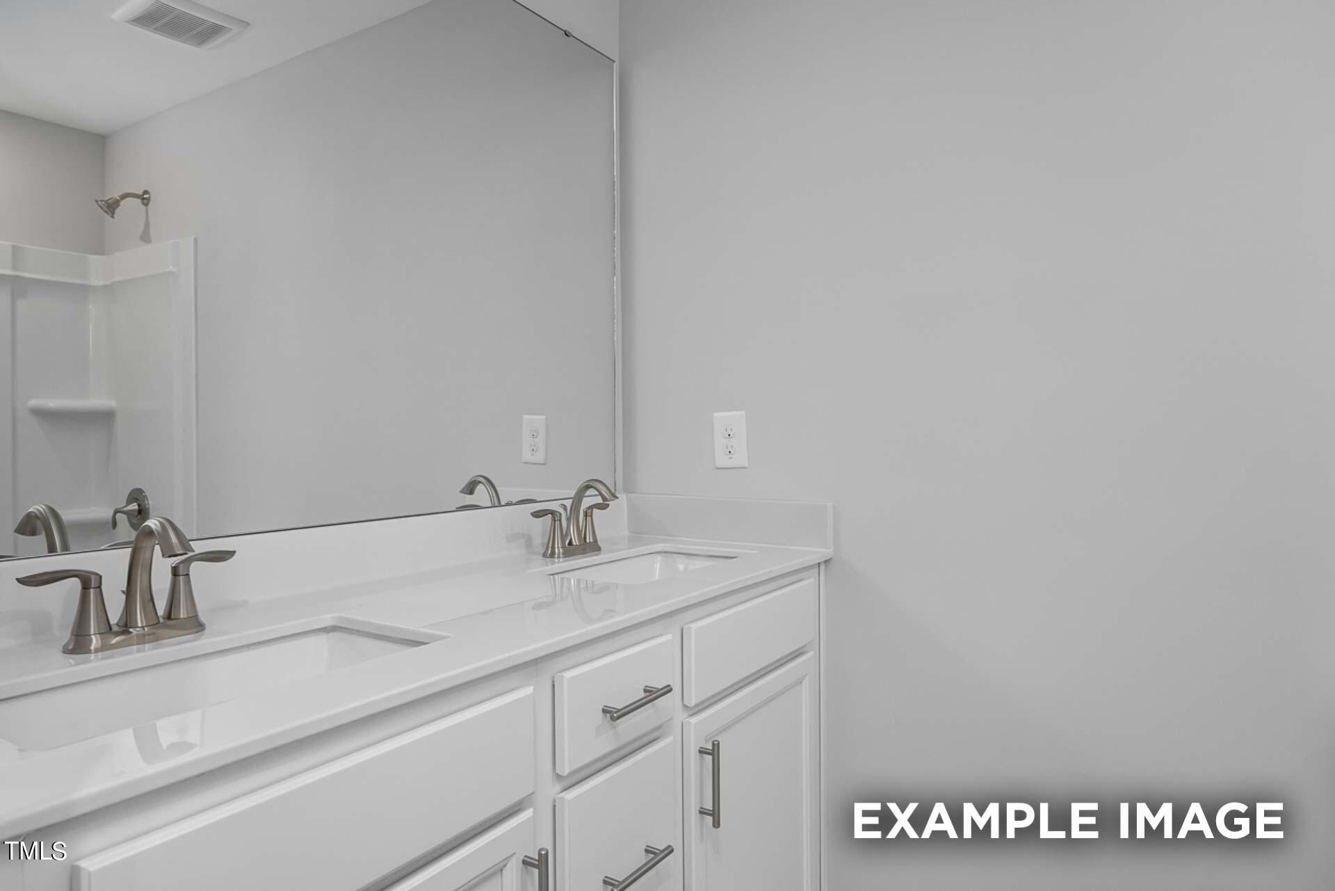 802 Rollingwheel Road Mebane, NC 27302 - Photo 25 of 40 a bathroom with a sink and a mirror
