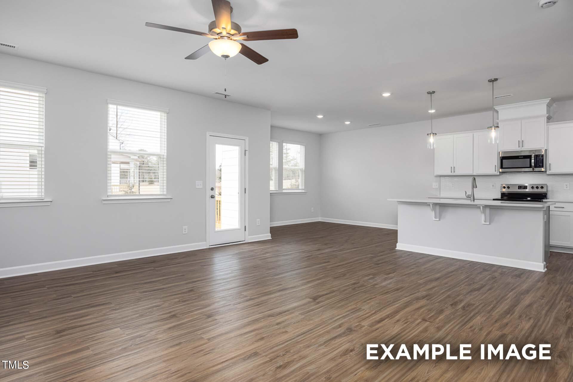 802 Rollingwheel Road Mebane, NC 27302 - Photo 5 of 40 a view of an empty room with window and wooden floor