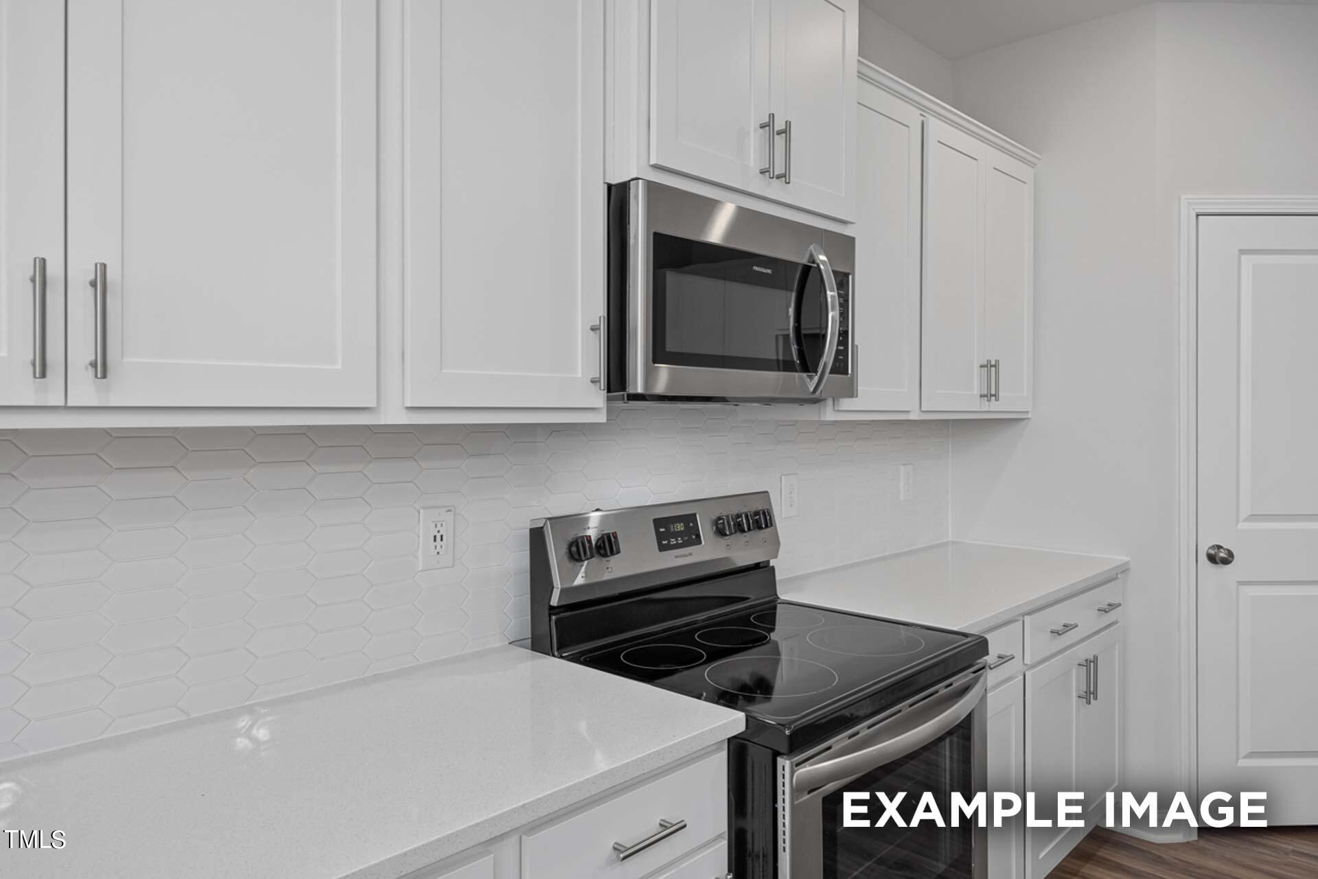802 Rollingwheel Road Mebane, NC 27302 - Photo 10 of 40 a kitchen with cabinets and steel appliances
