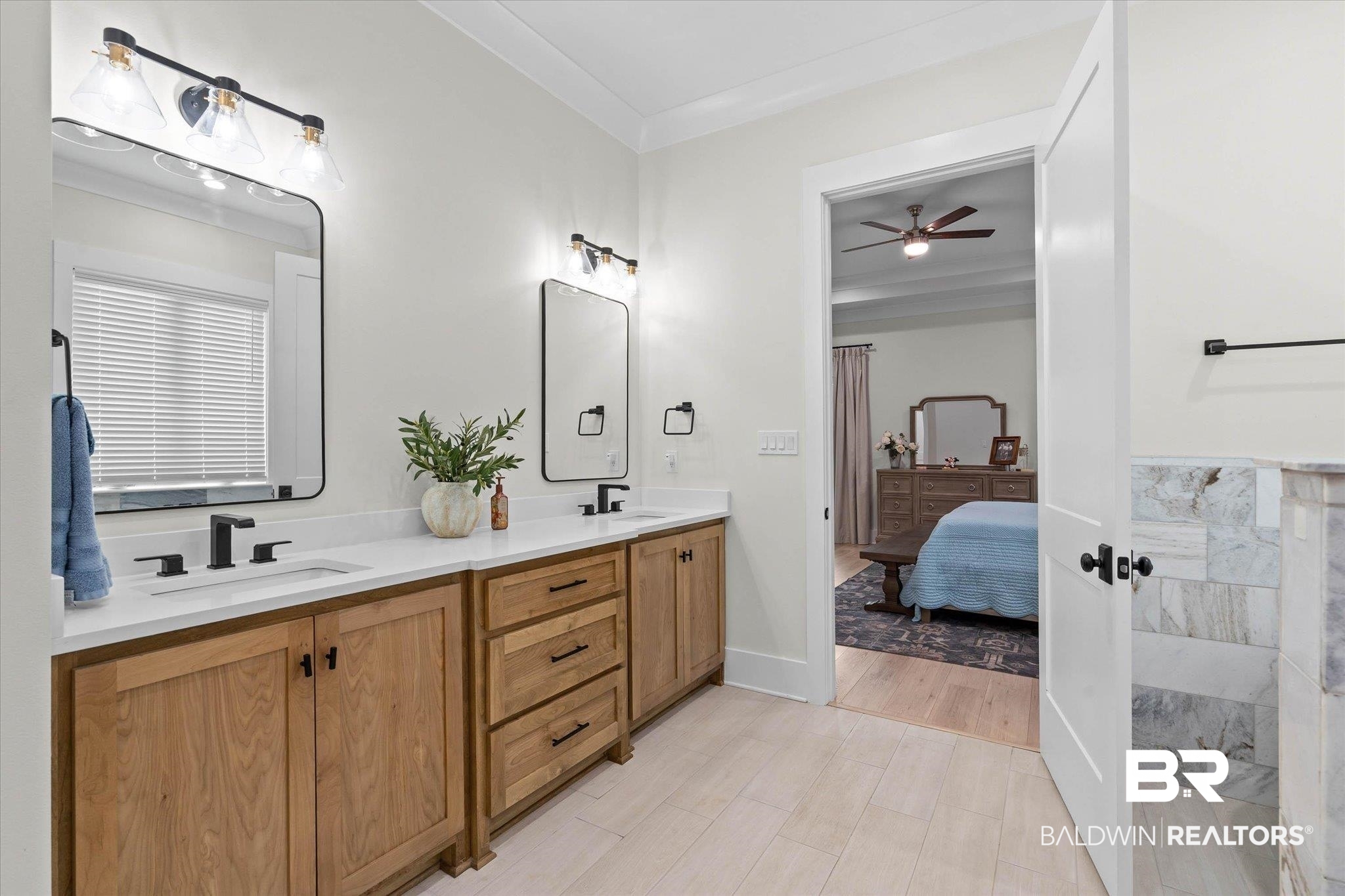 11 Creax Road Axis, AL 36505 - Photo 14 of 46 Dual wood-finish vanities with white countertops and undermount sinks