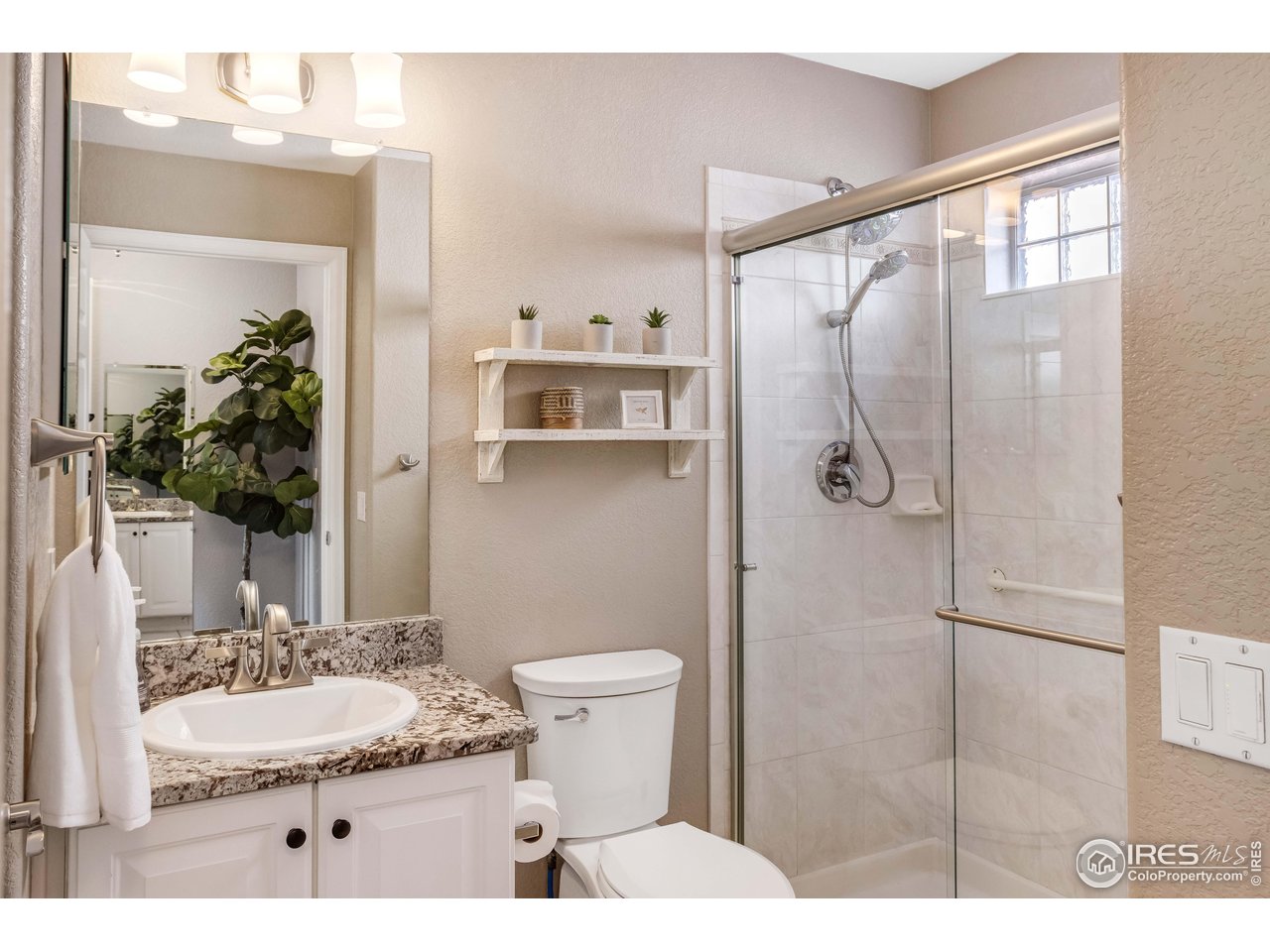 11737 Zenobia Loop Westminster, CO 80031 - Photo 19 of 39 a bathroom with a sink and a mirror