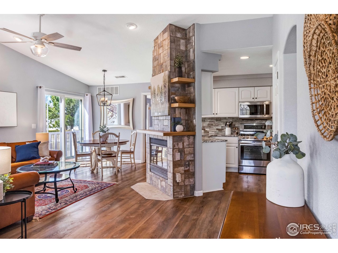 11737 Zenobia Loop Westminster, CO 80031 - Photo 6 of 39 a living room with stainless steel appliances furniture and a kitchen view