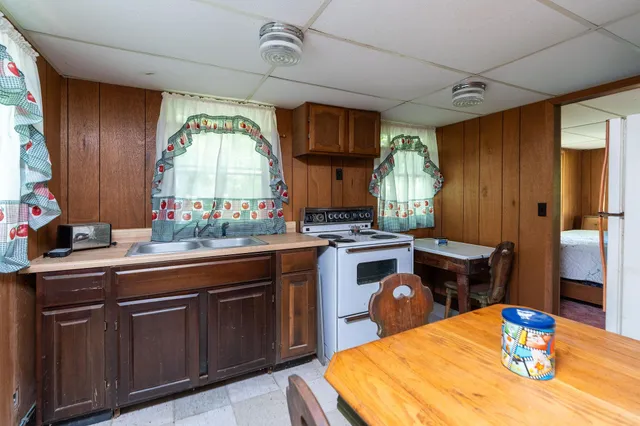 a kitchen with sink a window and dining table